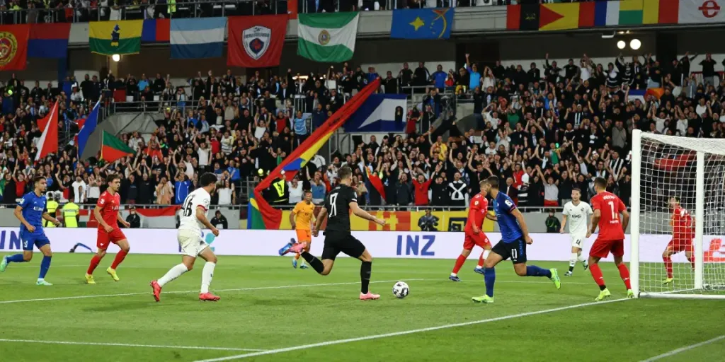 Action-packed soccer match with players focused on the ball and cheering crowd, illustrating the excitement of ผลบอลสด.